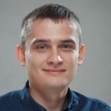 The photo of Oleksii Andrusenko, the founder of GrowPad, on the gray background.